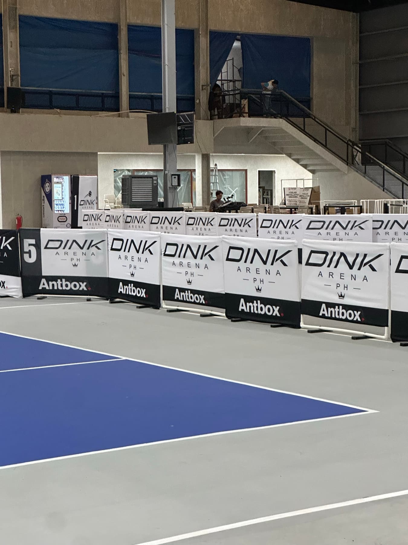 Dink Arena PH branded court barriers beside a finished pickleball court